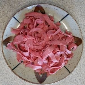 corned beef cut into ribbons for Reuben Pizza